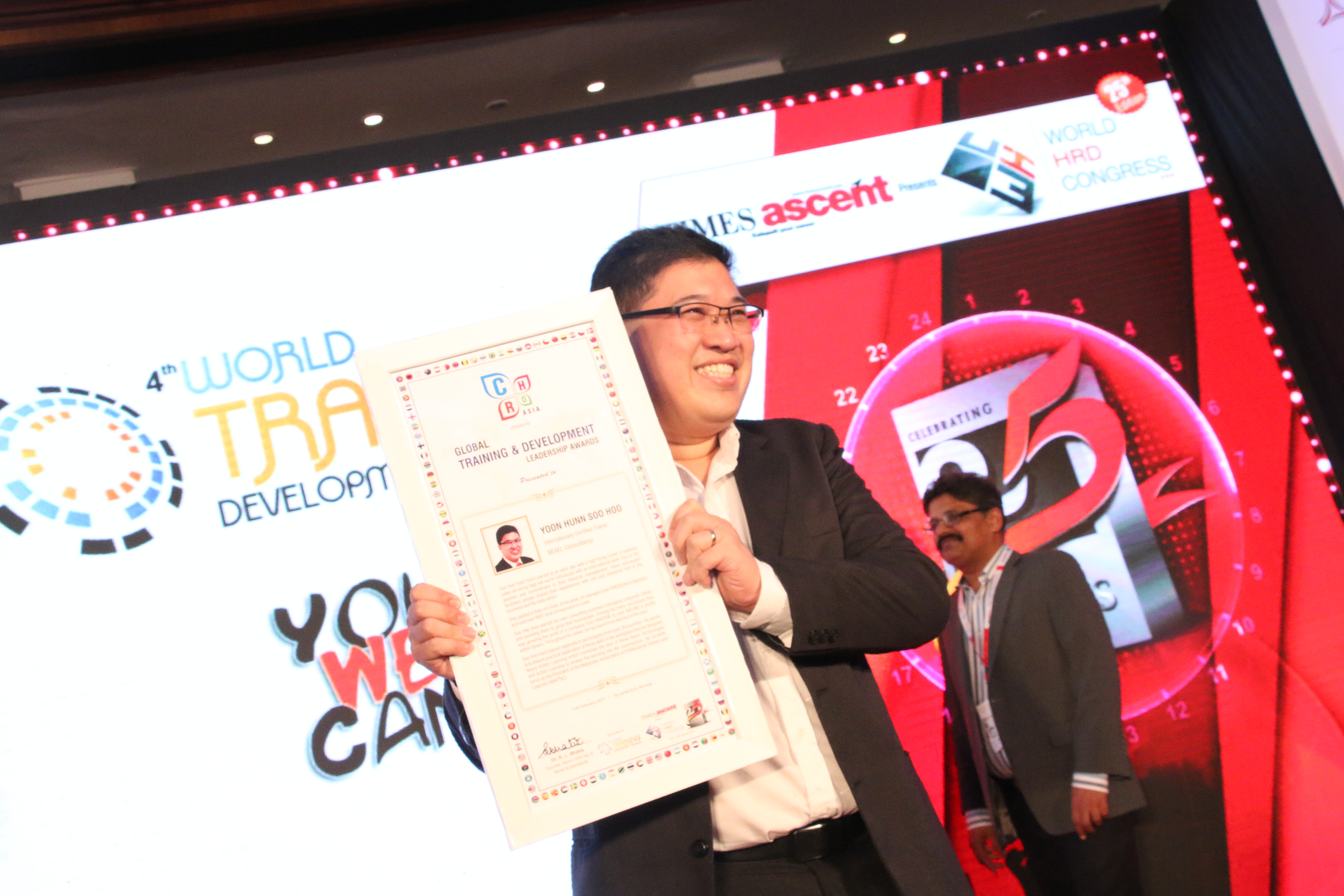 Soo Hoo Yoon Hunn receiving an industry award on stage